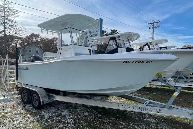 Slide: The Image of 2021 Release 210 RX boat on trailer at marine store. - 2