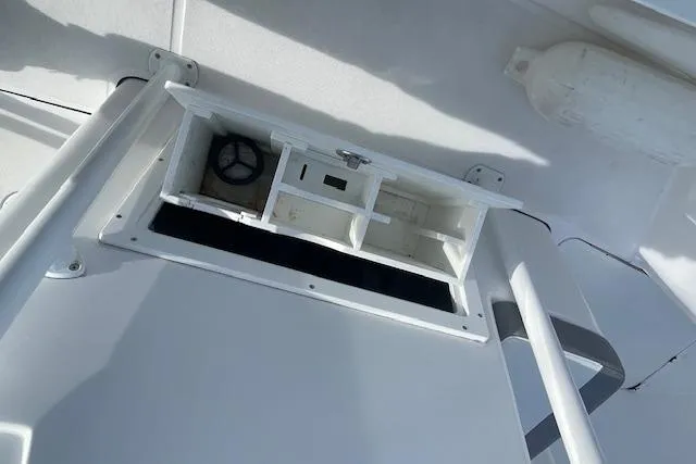 Slide: The Image of Open storage compartment on 2021 Release 210 RX boat ceiling. - 21