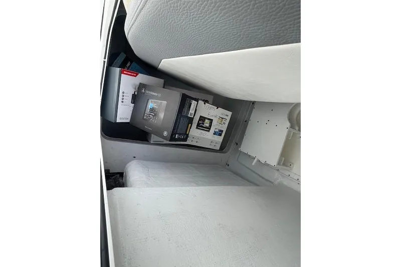 Slide: The Image of Storage compartment in a 2021 Release 210 RX, containing various electronic boxes. - 22