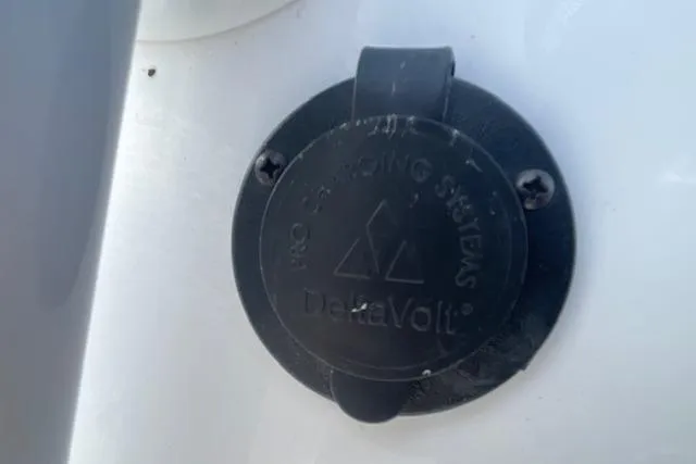 Slide: The Image of Charging port cover on 2021 Release 210 RX boat, featuring DeltaVolt branding. - 27
