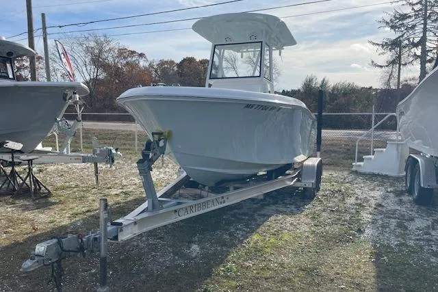 Slide: The Image of 2021 Release 210 RX boat on trailer, parked outdoors under clear sky. - 3