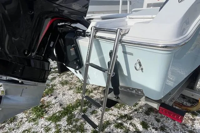 Slide: The Image of 2021 Release 210 RX boat with motor and ladder on snowy ground. - 7