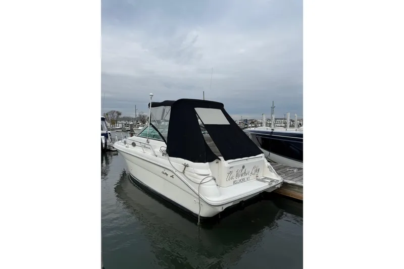The Image of 1996 Sea Ray 270 Sundancer boat docked at marina, overcast sky. - 1