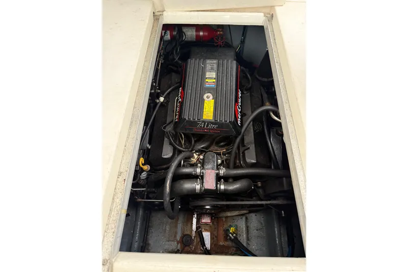 Slide: The Image of Engine compartment of a 1996 Sea Ray 270 Sundancer boat, featuring a 7.4L MerCruiser engine. - 13