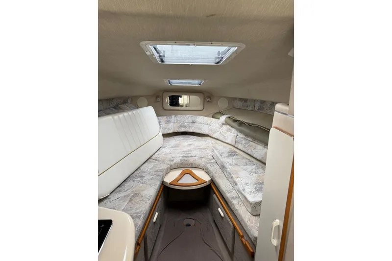 Slide: The Image of 1996 Sea Ray 270 Sundancer cabin interior with seating and skylight. - 16