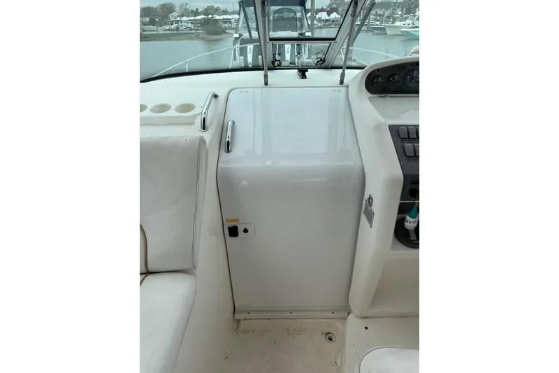 Slide: The Image of 1996 Sea Ray 270 Sundancer cockpit with steering controls and seating area. - 21