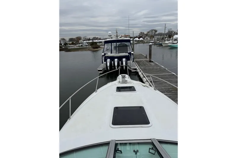 Slide: The Image of 1996 Sea Ray 270 Sundancer docked at marina with overcast sky. - 22