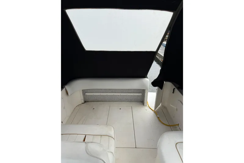 Slide: The Image of Interior view of 1996 Sea Ray 270 Sundancer boat with seating and covered deck. - 25