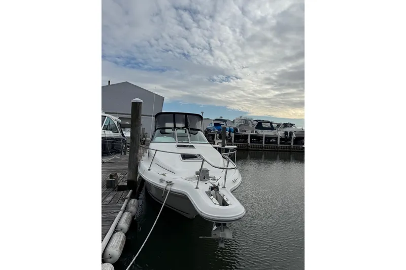 Slide: The Image of 1996 Sea Ray 270 Sundancer docked at marina under cloudy sky. - 6