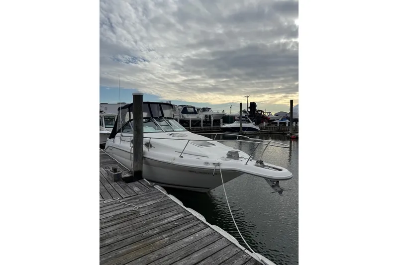 Slide: The Image of 1996 Sea Ray 270 Sundancer docked at marina under cloudy sky. - 7