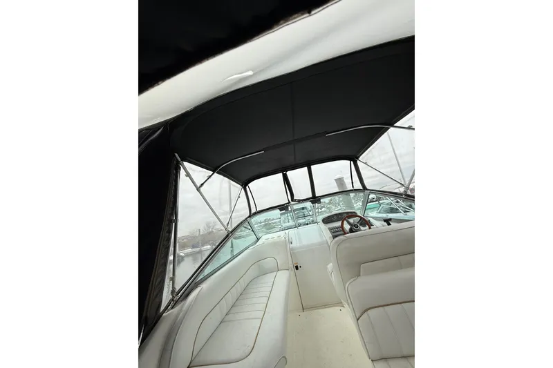 Slide: The Image of Interior view of 1996 Sea Ray 270 Sundancer boat with seating and steering wheel. - 9