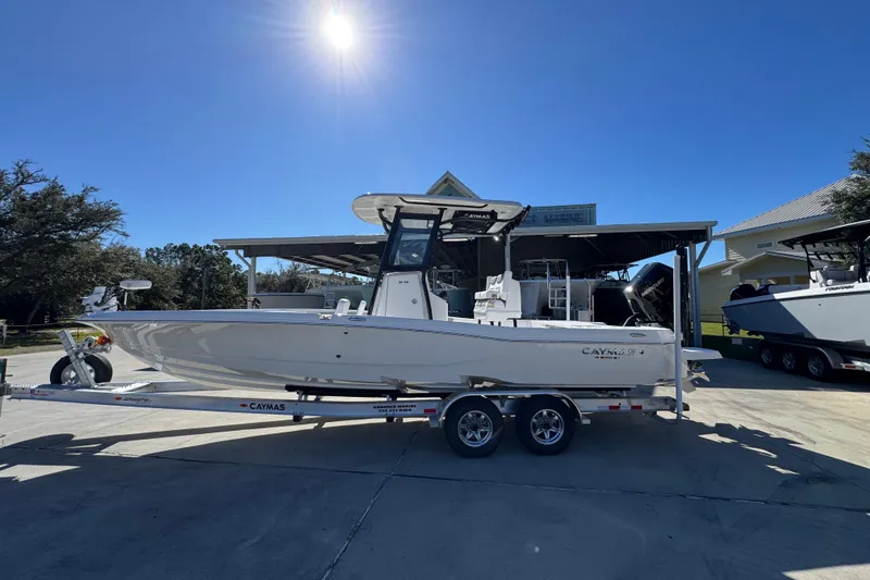 The Image of 2026 Caymas 28 HB boat on trailer under clear blue sky. - 1
