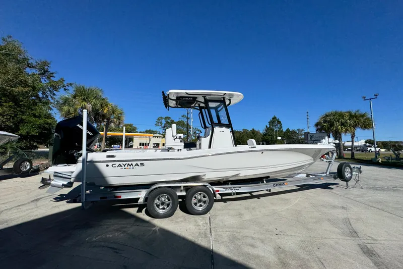 Slide: The Image of 2026 Caymas 28 HB boat on trailer under clear blue sky. - 11
