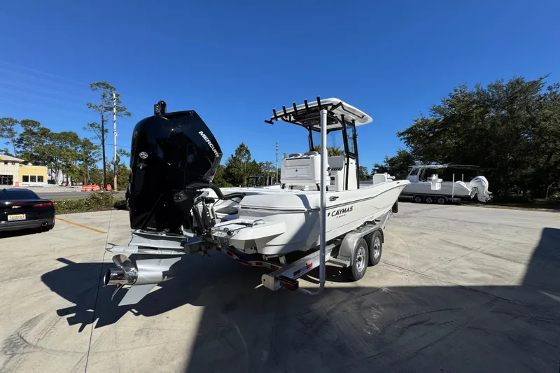 Slide: The Image of 2026 Caymas 28 HB boat with Mercury engine on trailer in sunny outdoor setting. - 13