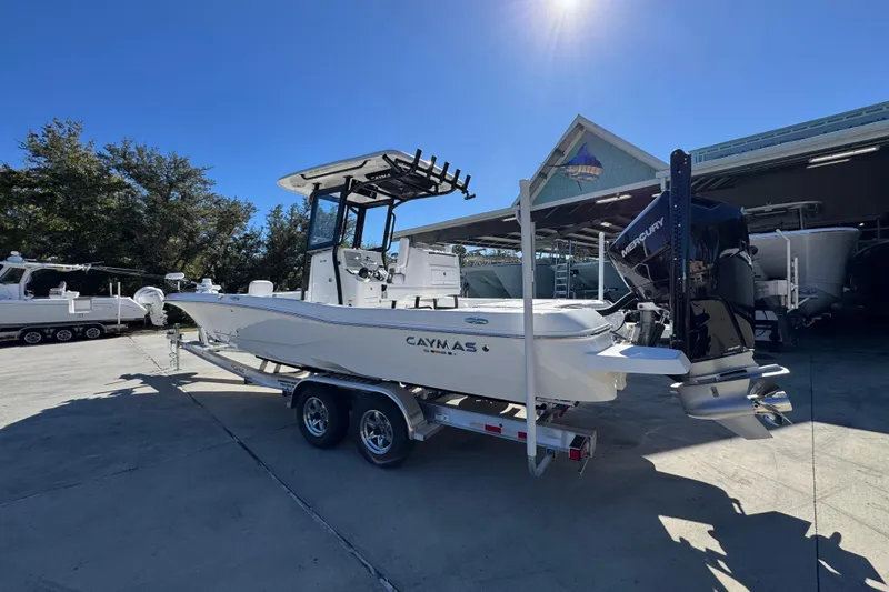 Slide: The Image of 2026 Caymas 28 HB boat on trailer, parked outdoors under clear blue sky. - 17