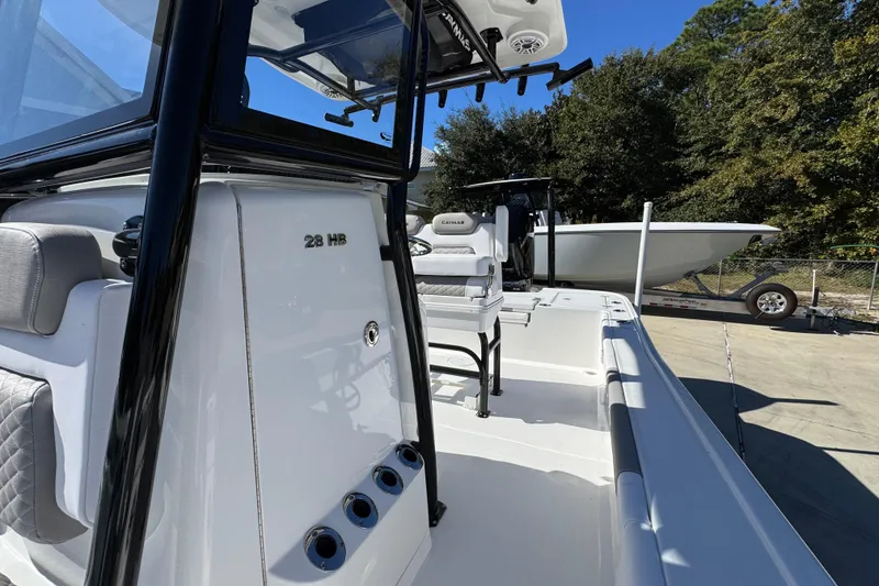 Slide: The Image of 2026 Caymas 28 HB boat with sleek design and modern features, docked outdoors. - 25