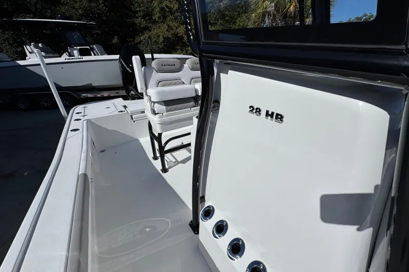 Slide: The Image of 2026 Caymas 28 HB boat interior with seating and console details. - 26
