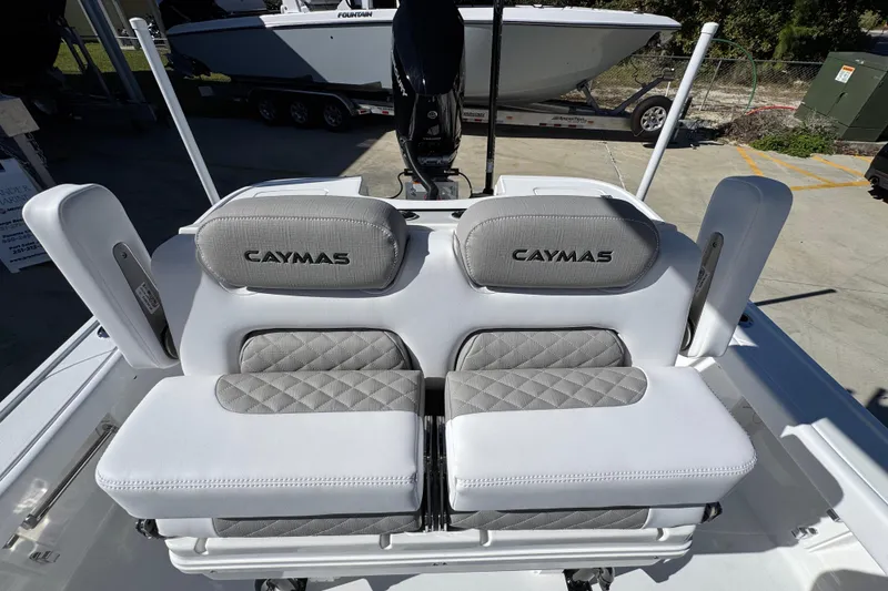 Slide: The Image of 2026 Caymas 28 HB boat seats with gray and white upholstery, outdoor setting. - 28