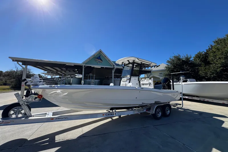 Slide: The Image of 2026 Caymas 28 HB boat on trailer under clear blue sky. - 3