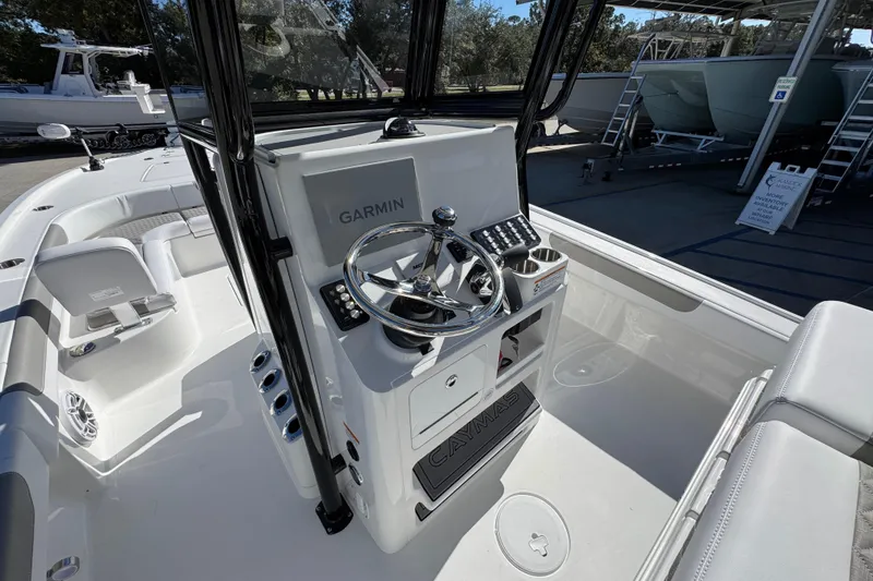 Slide: The Image of 2026 Caymas 28 HB boat interior with Garmin navigation system and sleek steering console. - 30