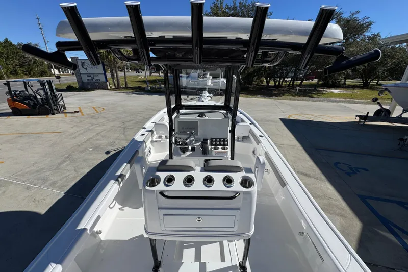 Slide: The Image of 2026 Caymas 28 HB boat interior with steering console and rod holders. - 35