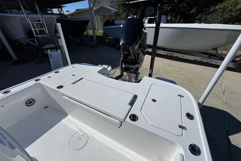 Slide: The Image of 2026 Caymas 28 HB boat with Mercury engine, docked outdoors. - 36