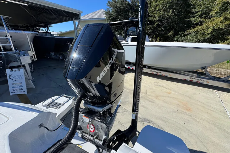 Slide: The Image of 2026 Caymas 28 HB boat with Mercury engine and Power-Pole, parked outdoors. - 38