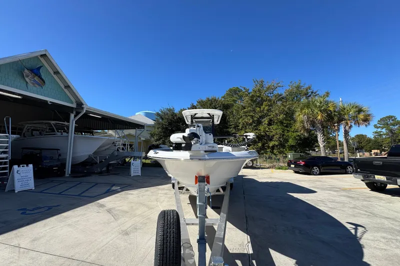 Slide: The Image of 2026 Caymas 28 HB boat on trailer at dealership under clear blue sky. - 6