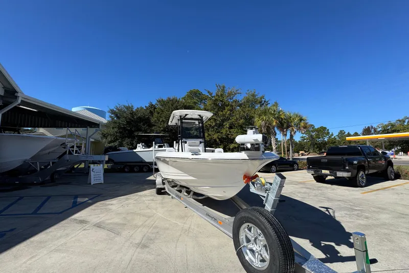 Slide: The Image of 2026 Caymas 28 HB boat on trailer under clear blue sky. - 7