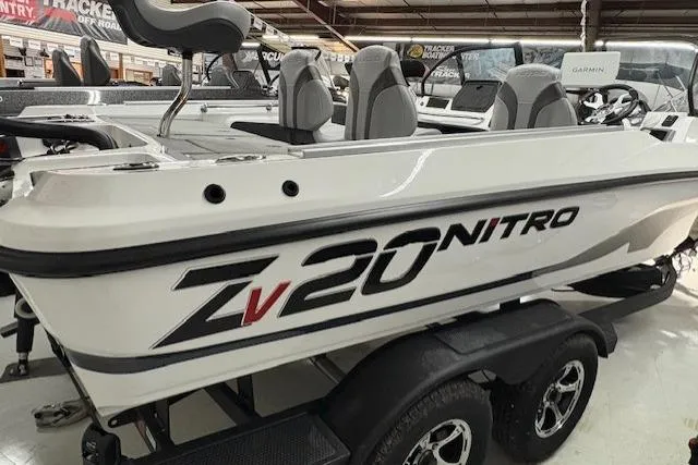 Slide: The Image of 2026 Nitro ZV20 Sport Pro boat displayed in showroom, featuring sleek design and modern seating. - 2