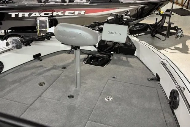 Slide: The Image of 2026 Nitro ZV20 Sport Pro boat interior with Garmin system and Tracker boat in background. - 8