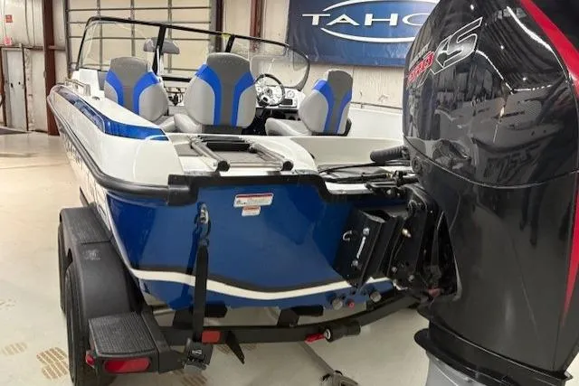 Slide: The Image of 2026 Nitro ZV19 Pro boat with blue and gray seating, displayed indoors. - 1