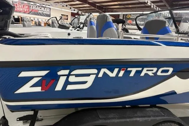 Slide: The Image of 2026 Nitro ZV19 Pro boat in showroom, blue and white design, sleek seating. - 5
