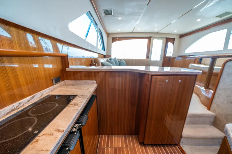 Slide: The Image of Luxurious interior of 2008 Viking 42 Convertible yacht with modern kitchen and seating area. - 36