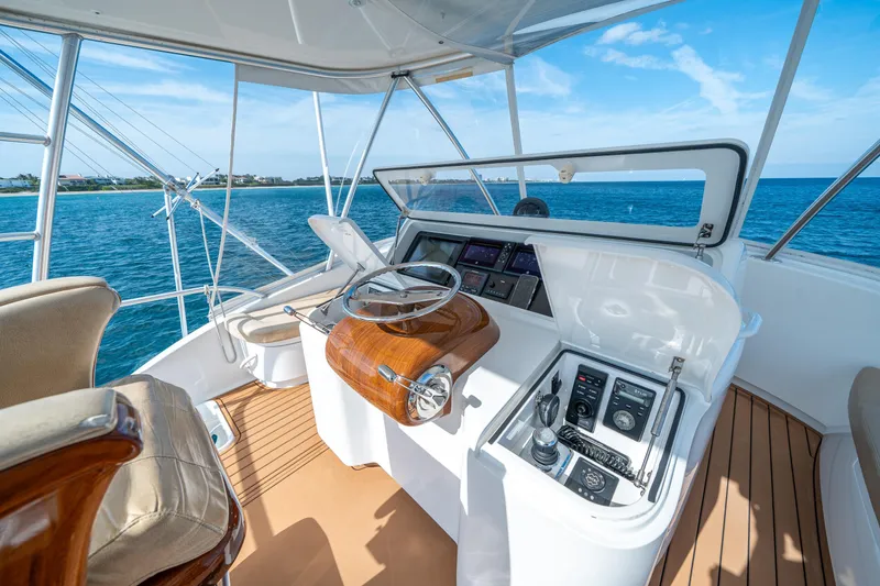 Slide: The Image of 2008 Viking 42 Convertible yacht helm with ocean view and modern controls. - 50