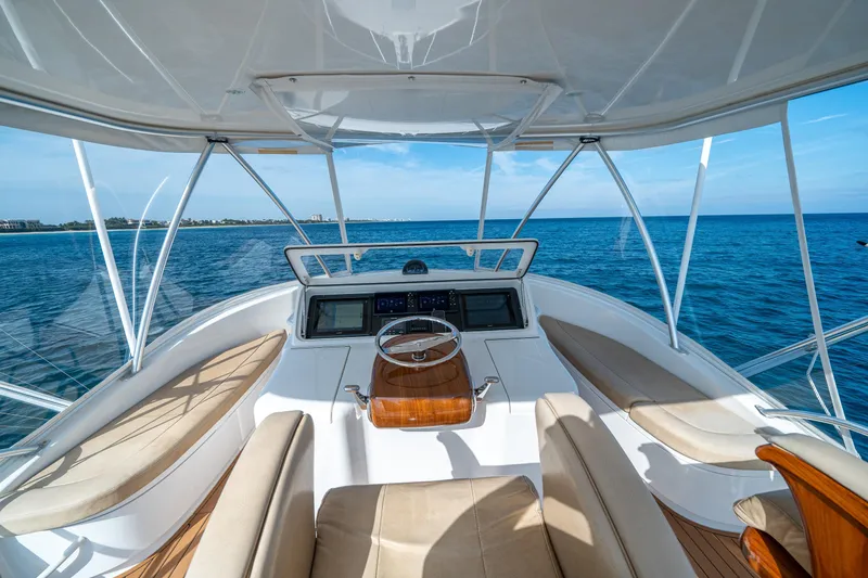 Slide: The Image of 2008 Viking 42 Convertible yacht helm with ocean view and luxurious seating. - 55
