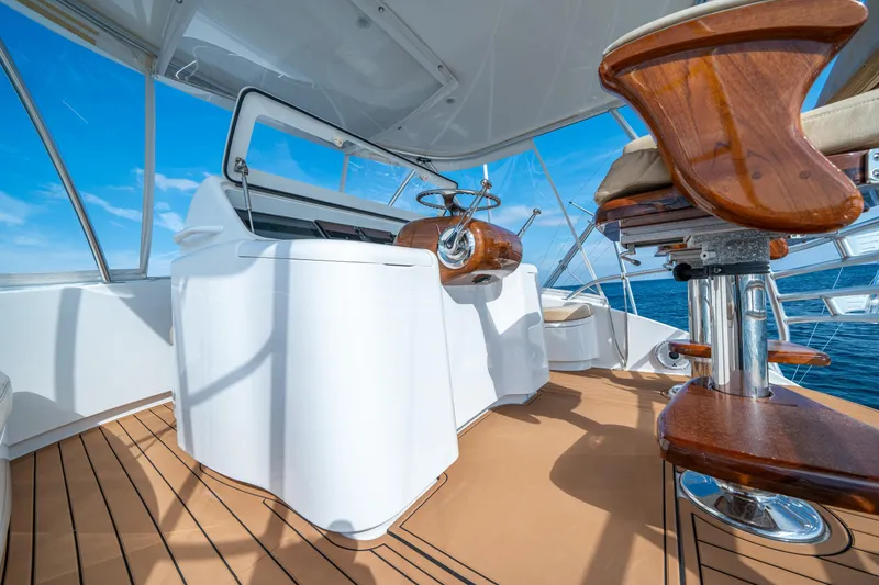 Slide: The Image of 2008 Viking 42 Convertible yacht helm with wooden accents and ocean view. - 57