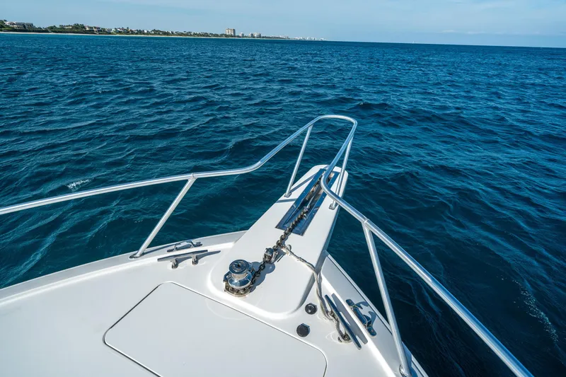 Slide: The Image of Bow of 2008 Viking 42 Convertible yacht cruising on open blue sea. - 58