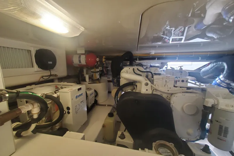 Slide: The Image of Engine room of 2015 Viking 42 Convertible yacht, featuring mechanical equipment and systems. - 66