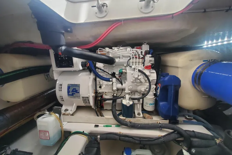 Slide: The Image of Engine room of 2015 Viking 42 Convertible boat, showcasing mechanical components and wiring. - 67