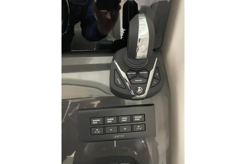 Slide: The Image of 2024 Pursuit DC 326 Dual Console dashboard with Garmin displays and JL Audio system. - 12