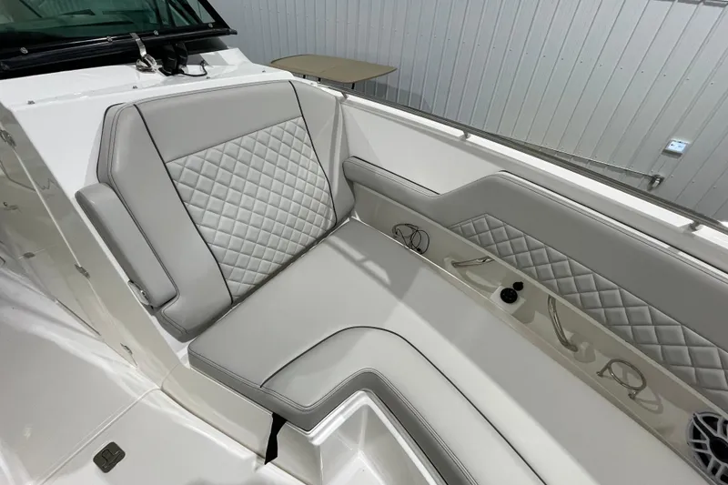 Slide: The Image of 2024 Pursuit DC 326 Dual Console boat interior with quilted seating and windshield. - 17
