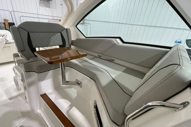 Slide: The Image of 2024 Pursuit DC 326 Dual Console boat interior with gray quilted seating. - 18