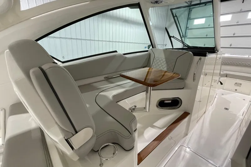 Slide: The Image of 2024 Pursuit DC 326 Dual Console boat interior with quilted seating and sleek design. - 19