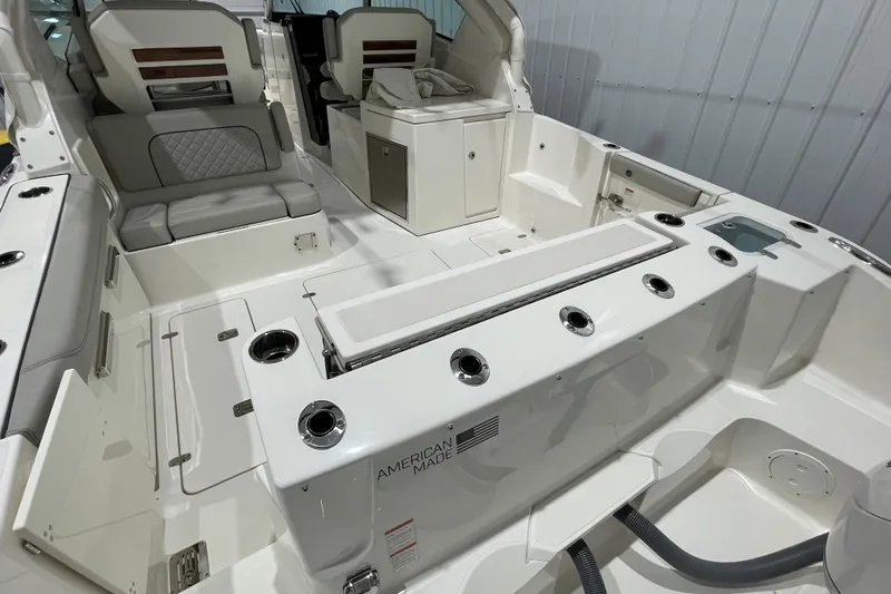 Slide: The Image of 2024 Pursuit DC 326 Dual Console interior with gray seating and wooden table. - 20