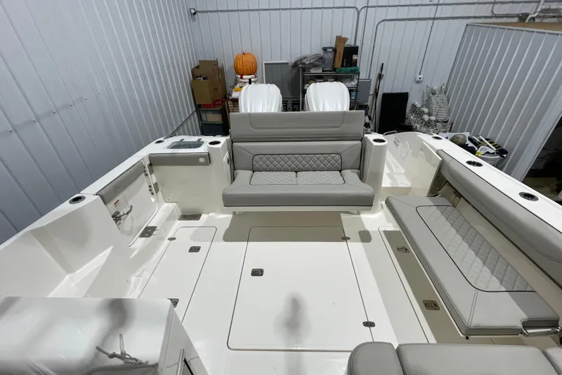 Slide: The Image of 2024 Pursuit DC 326 Dual Console boat interior with seating and storage features. - 22