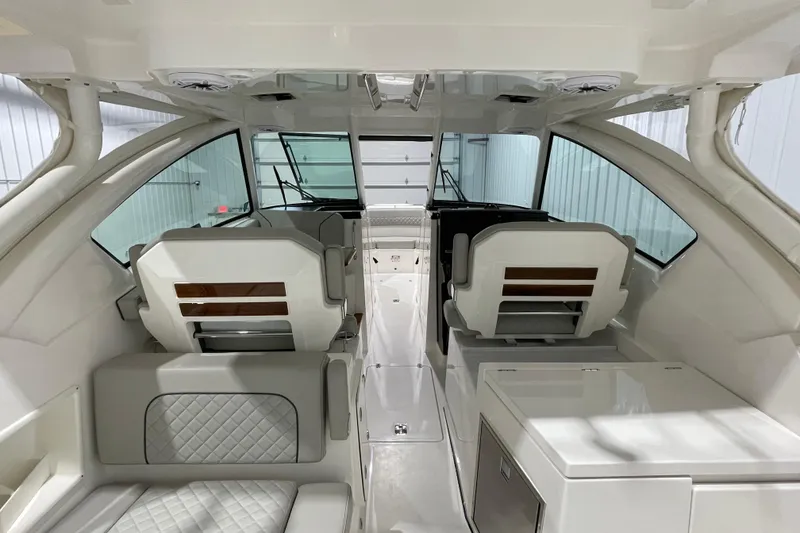 Slide: The Image of 2024 Pursuit DC 326 Dual Console boat interior with luxurious seating and modern design. - 23
