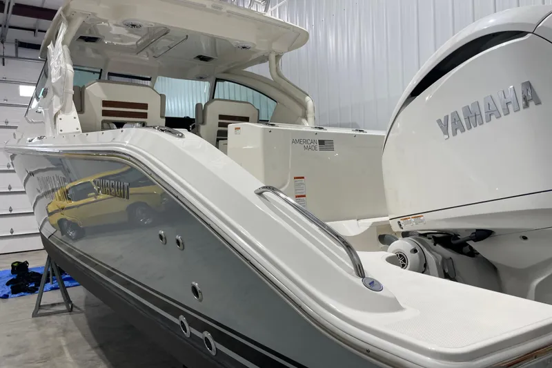 Slide: The Image of 2024 Pursuit DC 326 Dual Console interior with steering wheel and cushioned seating. - 4