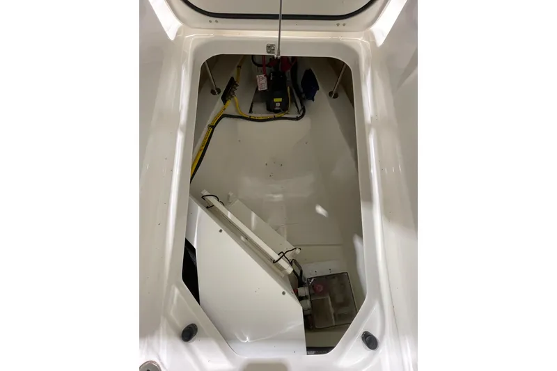 Slide: The Image of 2024 Pursuit DC 326 Dual Console storage compartment with wiring and equipment. - 40
