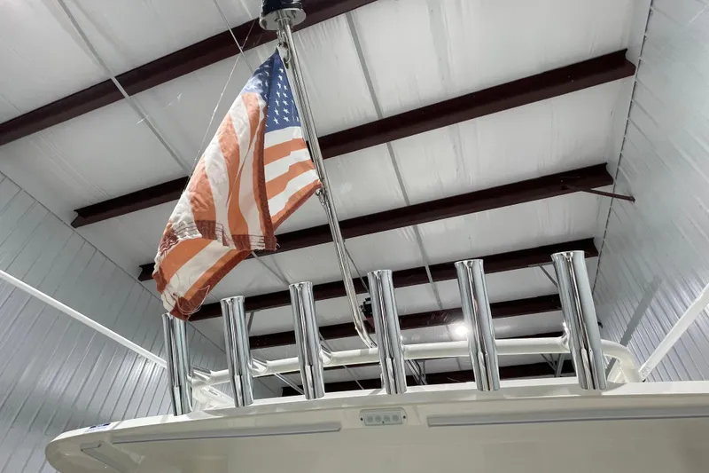 Slide: The Image of 2024 Pursuit DC 326 Dual Console with American flag in indoor storage. - 42